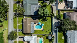 An aerial view of a residential area with a swimming pool, a house, and a road. - Luxury Pool Villa- 15 Mins to Hollywood Beach! (Hollywood)