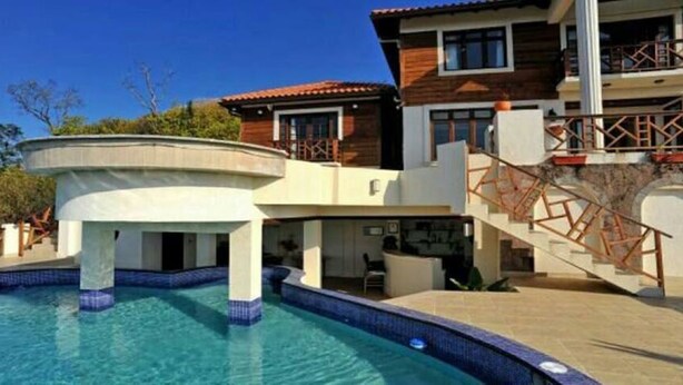 A modern two-story house with a swimming pool, wooden balconies, and a staircase. - Maison de La Mer (Castries)