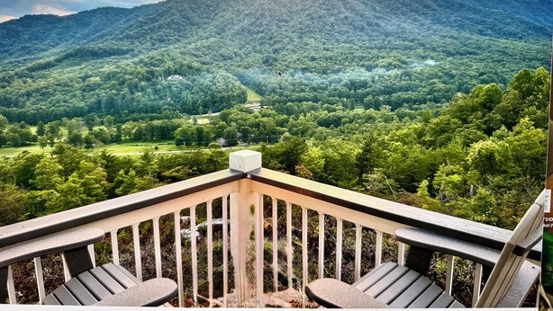 A deck with two chairs overlooking a forested mountain range. - "New Listing" Private Romantic Guest Loft with a VIEW! (Marion)