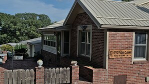 A brick building with a sign reading "T's Fish Camp Head on Down." - T's Fish Camp--Crappie Are Biting—Sleeps up to Six (Warsaw)