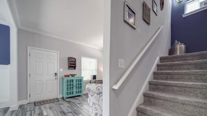 A staircase with a handrail leading to a landing. - 3-BR Getaway Near Center City/Plaza Midwood/NoDa! (Charlotte)