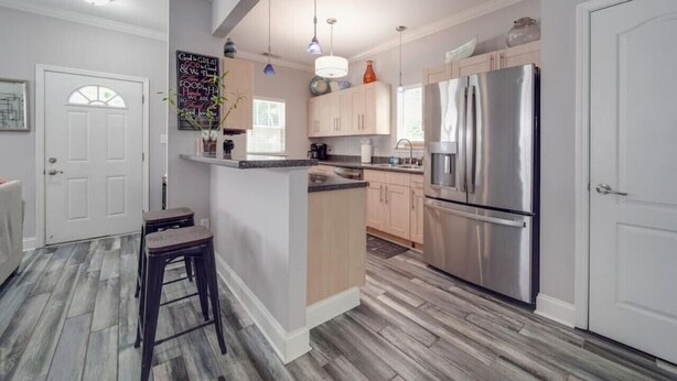 A modern kitchen with a central island, stainless steel appliances, and a light wood floor. - 3-BR Getaway Near Center City/Plaza Midwood/NoDa! (Charlotte)