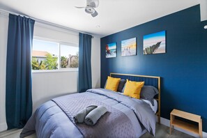 A bedroom with a bed, curtains, a ceiling fan, and artwork on the wall. - SinCity BEST L0CAT3D w POOL Home. 3min STRIP (Las Vegas)