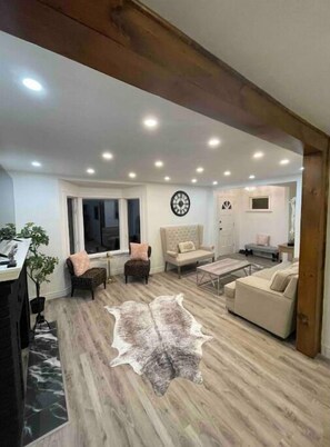 Relax in this stylish living room with a sofa, armchairs, and a coffee table.