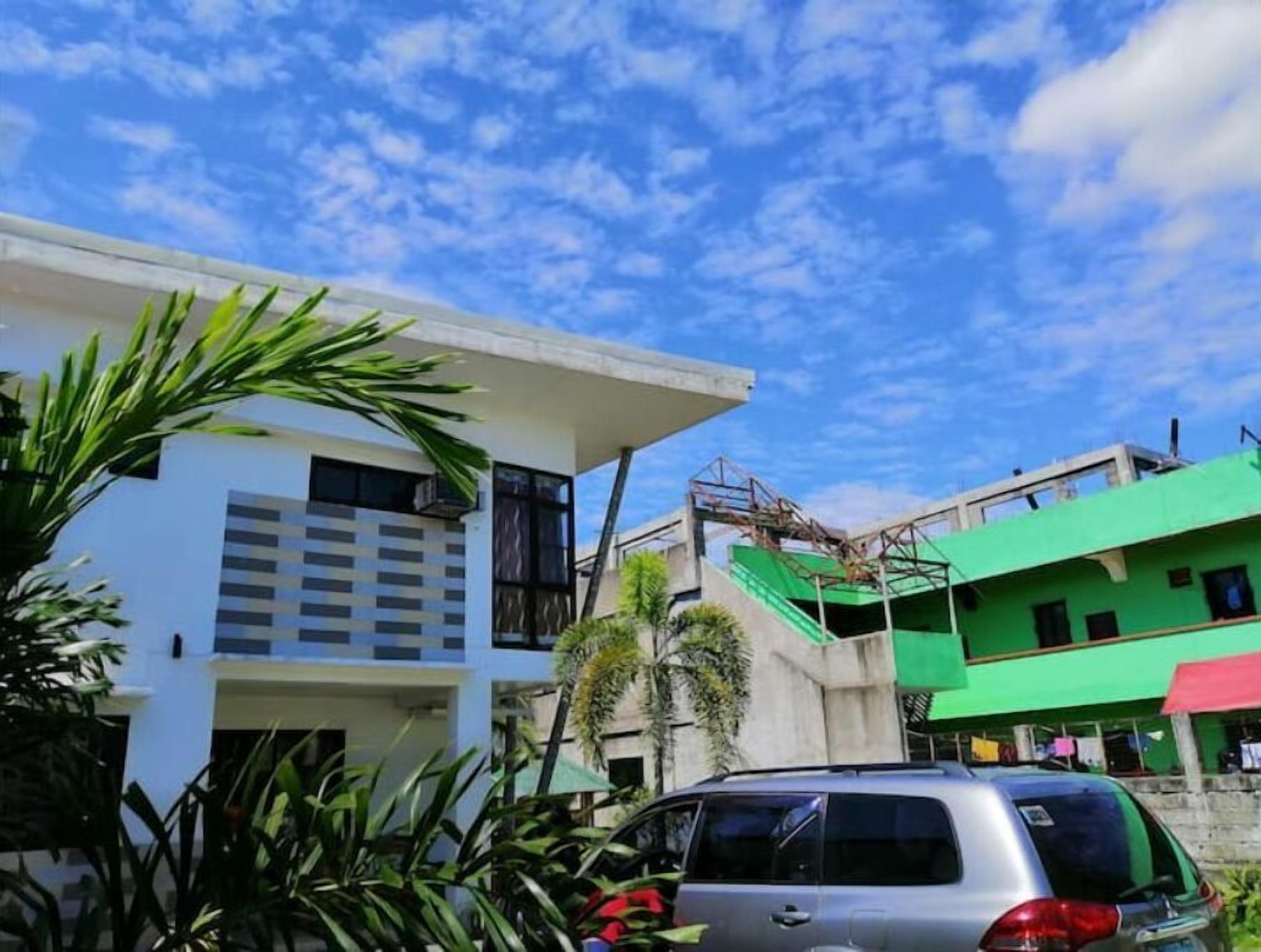 A modern building with a flat roof and a balcony.