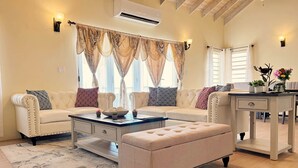 A living room with a sofa set, a coffee table, and a side table with decorative items.