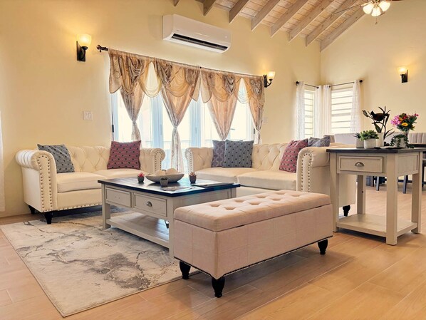 A living room with a sofa set, a coffee table, and a side table with decorative items.