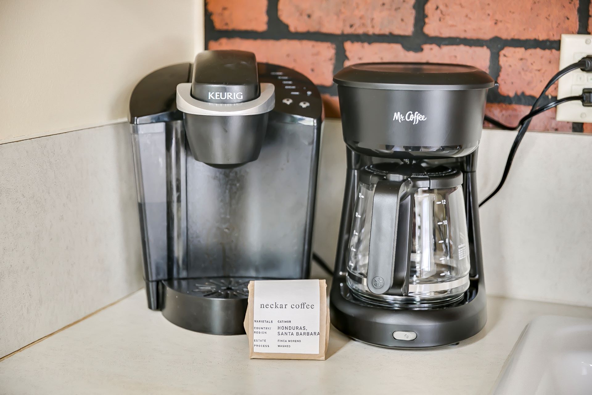 A Keurig coffee maker and a Mr. Coffee coffee maker on a countertop.