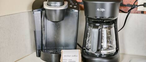 A Keurig coffee maker and a Mr. Coffee coffee maker on a countertop.