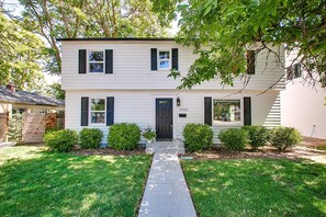 A two-story house with a front door, a mailbox, and a number 2420 on the wall. - The Valiant Vic (Boise)