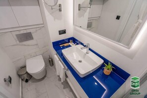 Apartment | Bathroom | Separate bathtub and shower, deep-soaking bathtub, hair dryer, slippers - Orbi City C Block 2-room Apt 27fl Sea-mount View (Batumi)