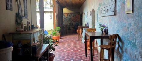 A room with a wooden ceiling, patterned floor, and a mural on the wall.
