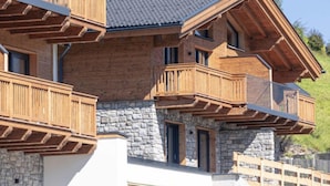 A multi-story building with wooden balconies and stone walls. - Premium # 1B mit Sauna by Interhome (Uttendorf)