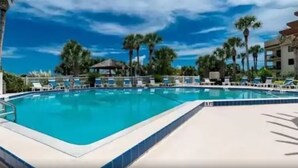 A swimming pool with lounge chairs and palm trees in the background. - Ocean Village Club-Sleeps 4 with First  Floor Access and Screen Porch (St. Augustine)