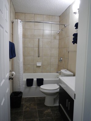Combined shower/bathtub, towels, soap, shampoo - The Shepherd's Inn (Charlie Lake)
