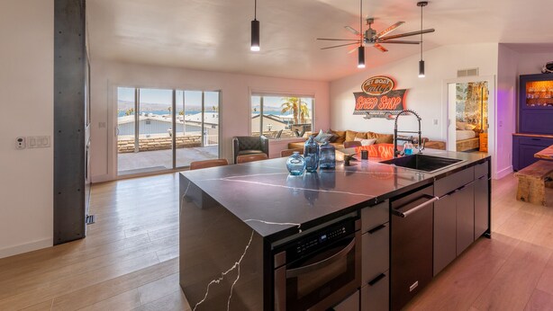 A spacious kitchen with a large island, modern appliances, and a view of the outdoors. - Jet Boat Billy's Speed Shop Havasu (needles)