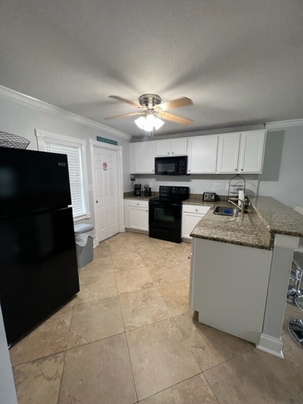 Enjoy cooking in this fully equipped kitchen with a microwave, oven, and countertop space.