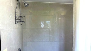 A shower with a handheld showerhead and a metal rack. - Hillcrest Motel By OYO Aurora IN Near Lawrenceburg (Aurora)