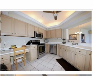 Enjoy cooking in this well-equipped kitchen with a stainless steel stove, microwave, and ample counter space.