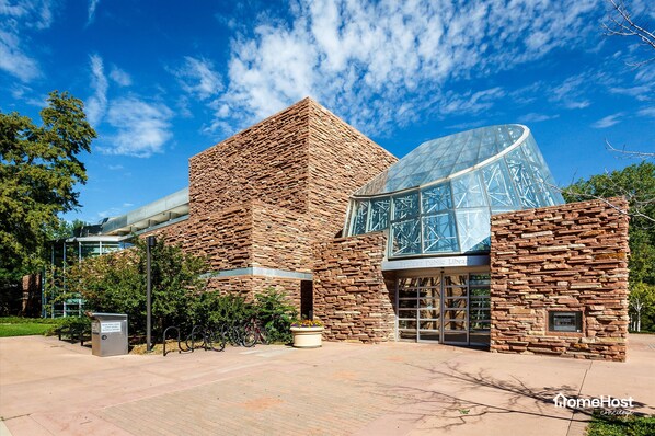 A modern building with a stone facade and a glass structure. - Pet-Friendly! Stunning Home — Steps to Downtown, CU & Hiking Trails. (Boulder)