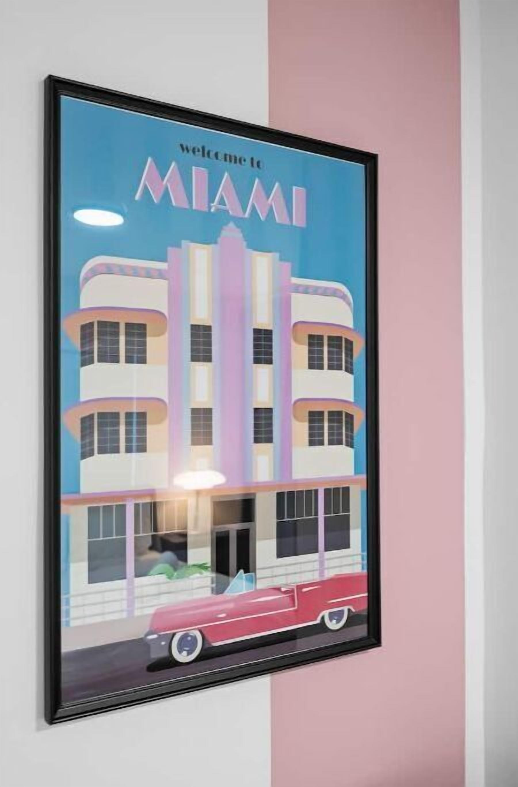 A framed poster with a building and a car, featuring the text "welcome to Miami".