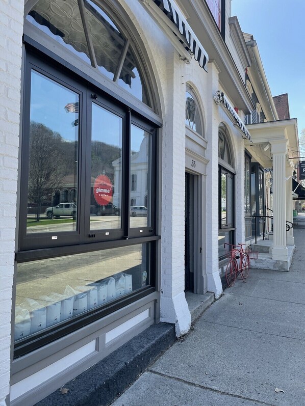 A building with large windows and a sign that reads "ginger coffee."