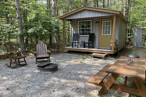 One bedroom cabin nestled on wooded private acre.