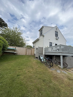 View from backyard. Outdoor shower, bicycles + surf board storage 