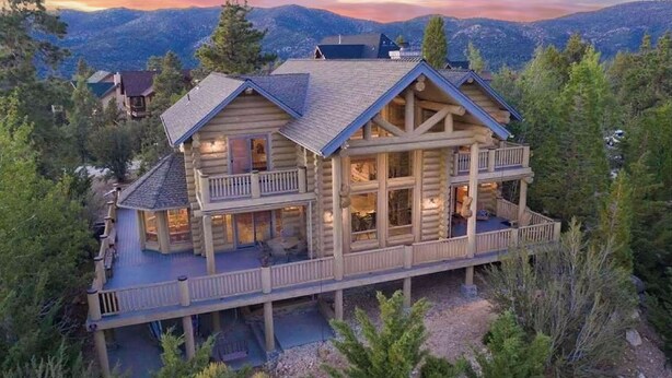 A large log cabin with a balcony, surrounded by trees and mountains. - Hot Tub, Game Room, Large Deck w/ Incredible View Penticton Lodge by Avantstay (Big Bear Lake)