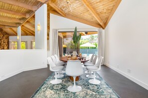 Enjoy meals in this stylish dining area with a high ceiling, round table, and six chairs.