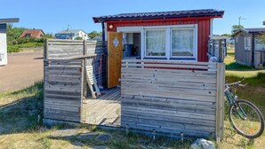 A small wooden structure with a red roof and a window, likely a storage shed or utility building. - Awesome home in Falkenberg (Falkenberg)