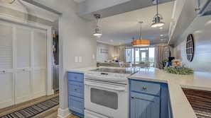 A kitchen with a stove, oven, and blue cabinets.