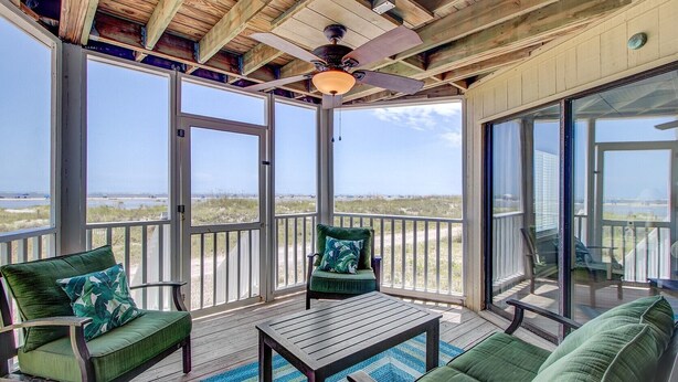 A covered outdoor deck with a wooden ceiling, a ceiling fan, and a view of the beach. - 103 B Port O Call by Avantstay Direct Beach Access Screened In Porch! (Isle of Palms)