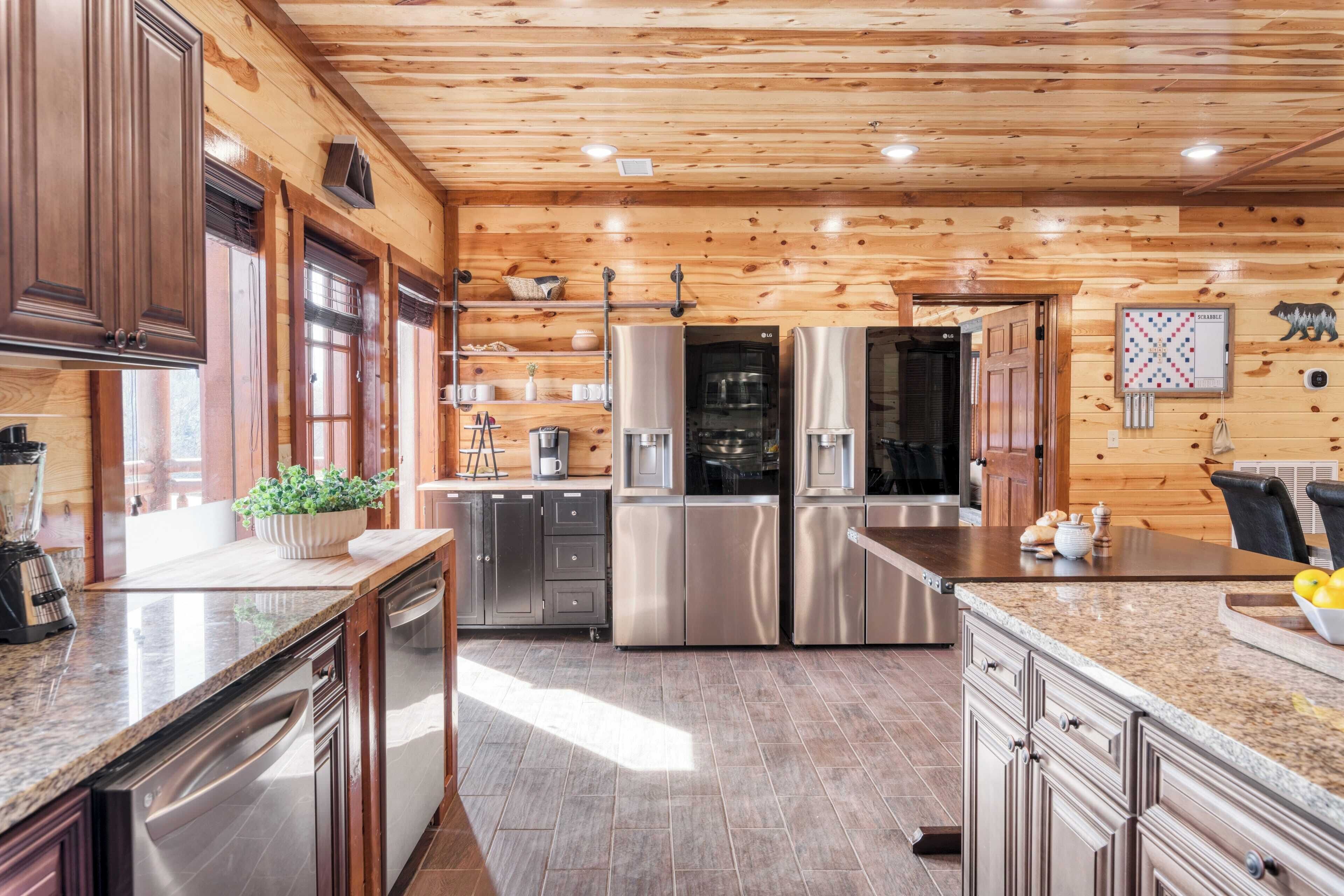 A modern kitchen with wooden walls, stainless steel appliances, and granite countertops.