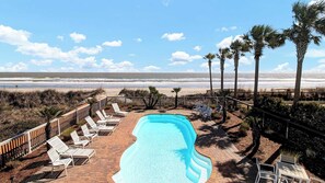 A pool area with lounge chairs and a view of the beach and ocean. - 502 Ocean Blvd by Avantstay Beachfront w/ Pool & Ocean Views! (Isle of Palms)