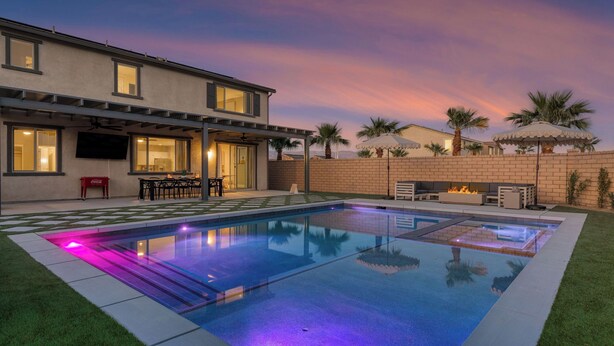 A modern house with a swimming pool, patio furniture, and a fire pit. - Sleeps 16! Pool Oasis w/ Game Room, Hot Tub, Fire Pit Desert Eden by Avantstay (Coachella)