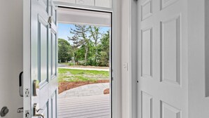 A white door with a glass panel, a metal handle, and a keyhole. - Cape Cod: Gimlet Getaway (Eastham)