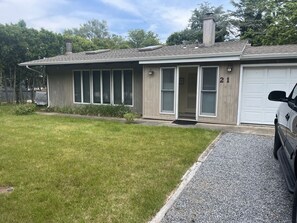 Stroll up to the front porch, where a welcoming door and two windows invite you to enter.