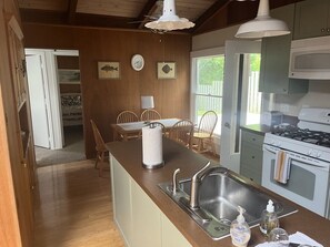 Enjoy a warm and inviting kitchen with a central island, stainless steel sink, and modern stove top oven.