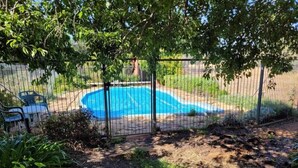 A backyard with a swimming pool surrounded by a metal fence. - "Talbot" Rustic style accommodation with Mod Cons (Katrine)