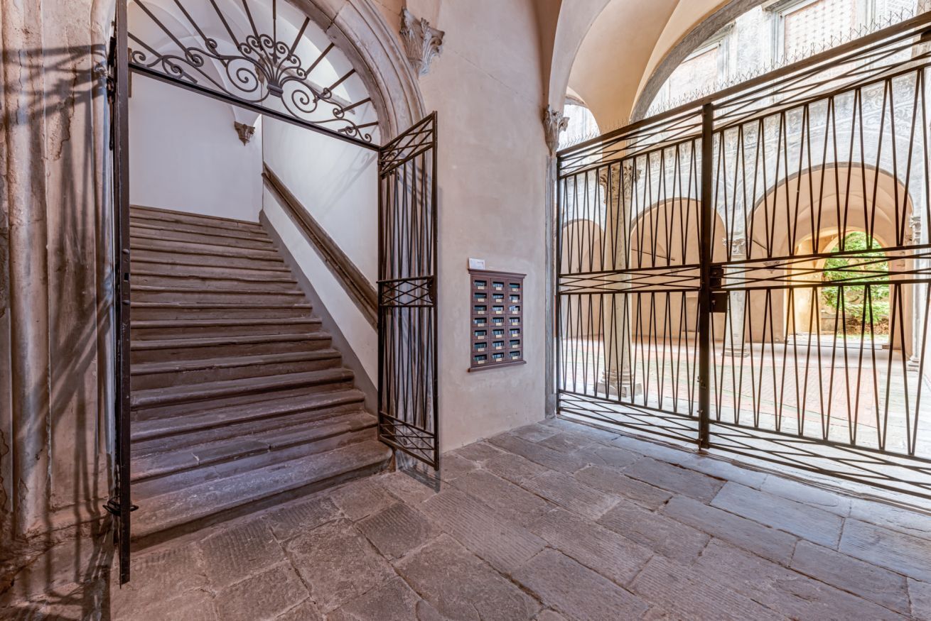 A stone staircase with metal railings leading to an upper level.