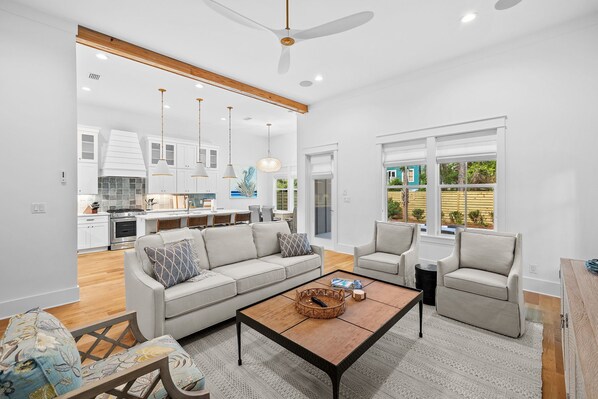 A modern living room with a sofa, armchairs, and a coffee table.