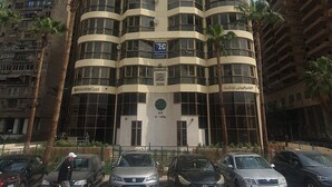 A tall, curved hotel building with multiple balconies and a central entrance. - Grand Bayan Hotel at Nile Plaza (Cairo)