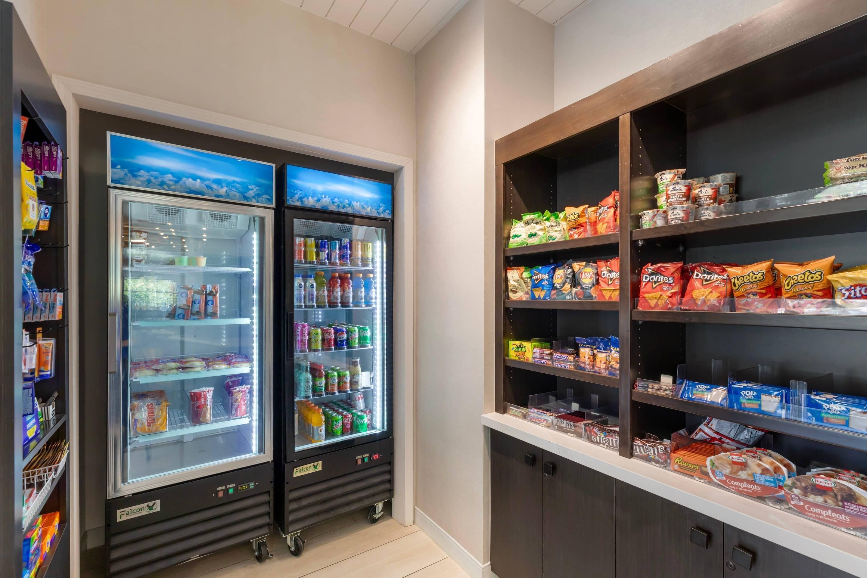 A vending area with snack machines and a refrigerated display case.