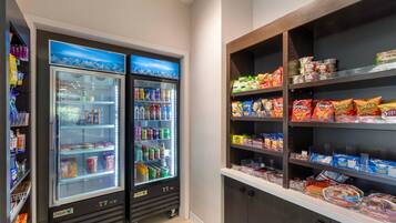 A vending area with snack machines and a refrigerated display case.