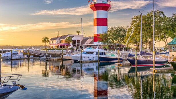 A lighthouse with a red and white striped tower, surrounded by a marina with several boats docked. - Pet Friendly ~ Marsh Views ~ Private Pool w/ Free Pool Heat ~ 25 Stoney Creek Rd (Hilton Head Island)