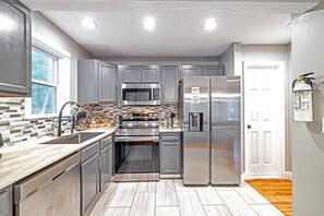 Una cocina moderna con electrodomésticos de acero inoxidable, un microondas y un refrigerador.