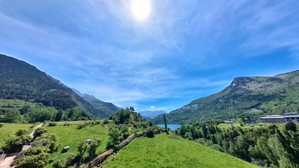 A mountainous landscape with a clear sky and a lake.