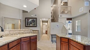 A spacious kitchen with granite countertops, wooden cabinets, and a central island. - Family-Friendly 3BR Retreat • Golf Course Views + Ticket Discounts (Branson)
