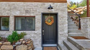 A stone house with a dark front door, a wreath, and a stone staircase leading to the entrance. - 20% Off Valentines Studio at Sundance Utah (Sundance)